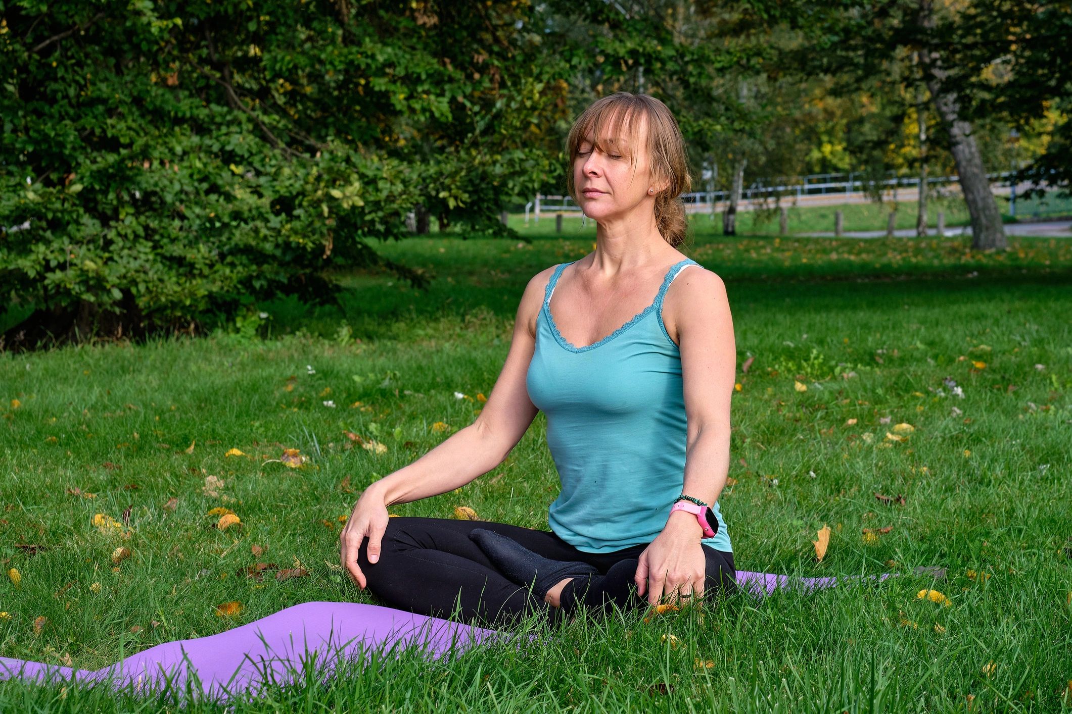 Woman meditating outdoors in a peaceful natural setting